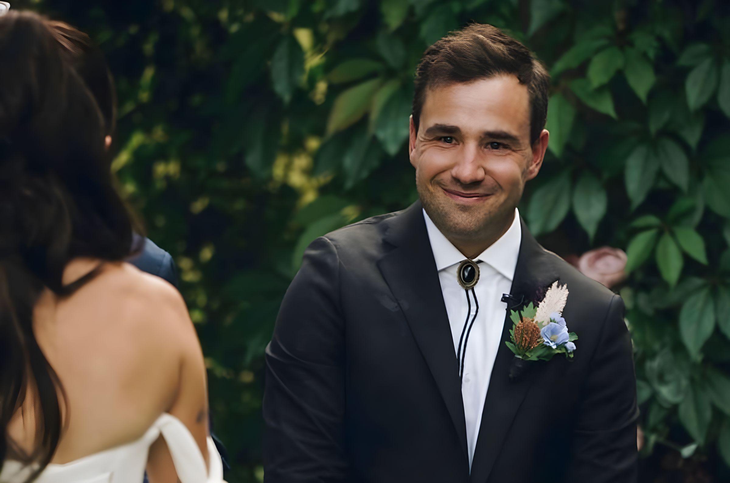 Groom with a bolo tie and dried-flower boutonniere